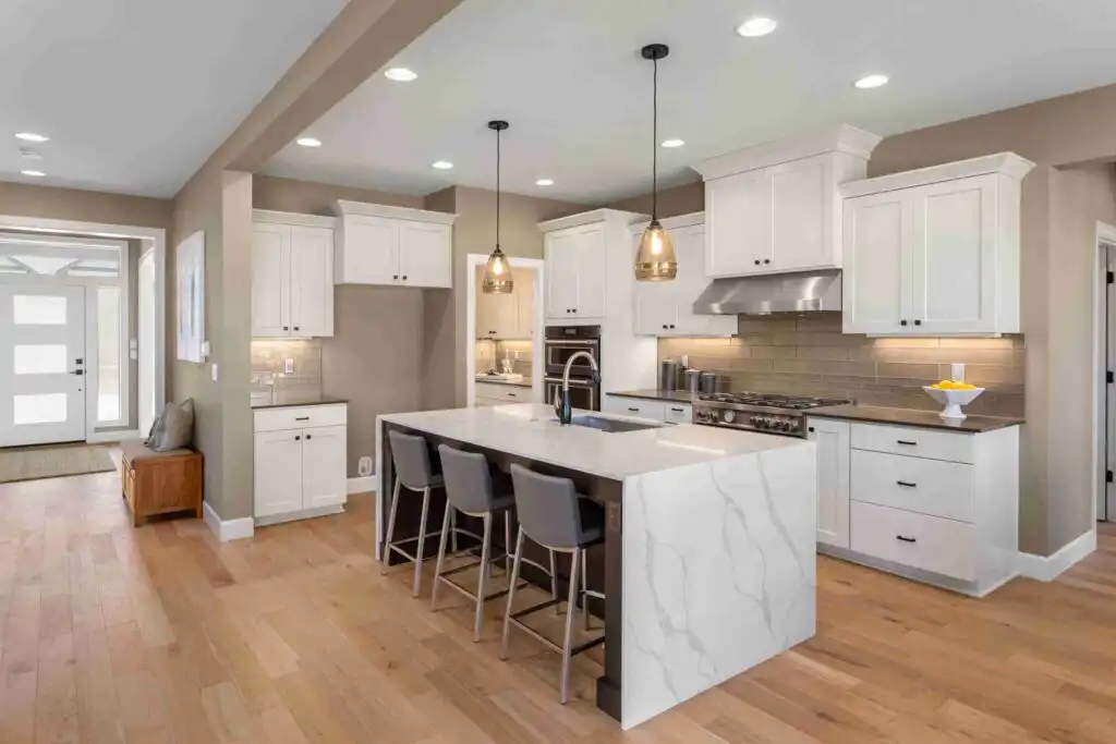Bright transitional white kitchen with marble island
