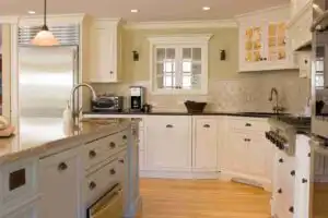 Refreshed cream shaker kitchen with granite counters and subway tile backsplash